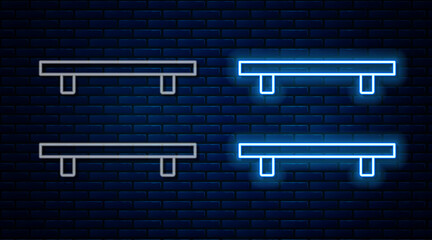 Sticker - Glowing neon line Empty wooden shelves icon isolated on brick wall background. Vector