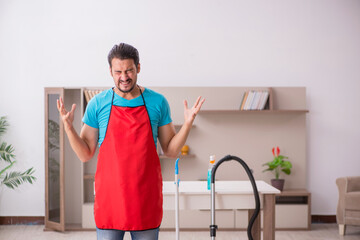 Wall Mural - Young male contractor cleaning the house