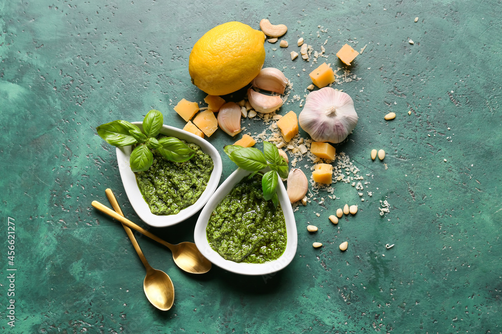 Composition with tasty pesto sauce on color background