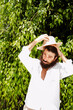 © javiemebravo - young man with beard and long hair wears hat and white shirt surrounded by greenery