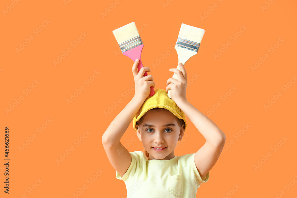 Little painter with brushes on color background