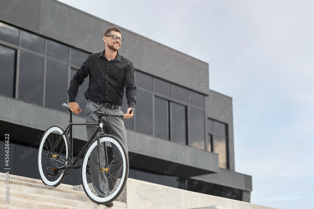 Businessman with bicycle on city street