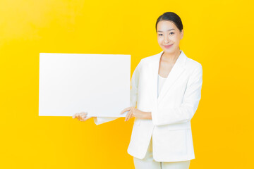 Wall Mural - Portrait beautiful young asian woman with empty white billboard