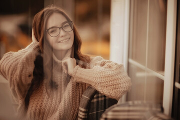 Wall Mural - happy girl autumn cafe sweater concept vision model with glasses posing