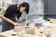 © Екатерина Елисафенко - the master sculpts a clay pot in his workshop