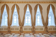 Tall Windows With Golden Curtains