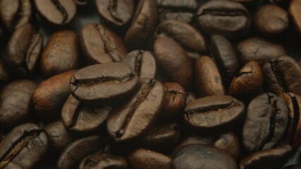 Wall Mural - coffee beans, close up dark brown roasted coffee beans background texture top view with round smooth motion, 4k