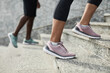 © Seventyfour - Close-up of sportsmen in sneakers running up on the stairs during training outdoors