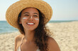 © New Africa - Beautiful African American woman with sun protection cream on face at beach