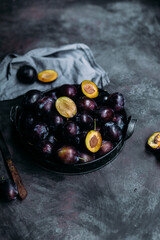 Ripe blue plums on a dark background