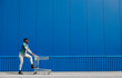© Shopping King Louie - black afro guy runs to shop with a shopping cart, the guy has fun and jumps, runs for purchases near the mall