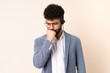 © luismolinero - Telemarketer Moroccan man working with a headset isolated on beige background having doubts