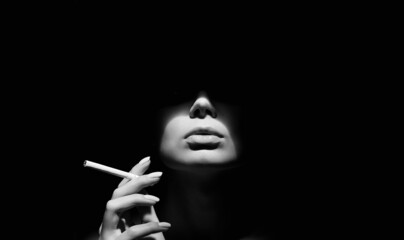 Wall Mural - Beautiful woman with a cigarette in the dark