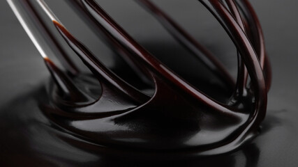 Wall Mural - Chocolate. Mixing liquid dark chocolate with whisk. Melted chocolate swirl. Confectioner prepares dessert, sauce