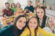 © deagreez - Self-portrait of attractive cheerful family eating domestic dish meeting showing v-sign good mood at home indoors