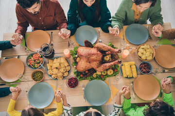 Canvas Print - High angle photo of dreamy pretty family celebrating thanks giving day sitting table holding arms praying indoors room home