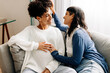 © (JLco) Julia Amaral - Queer parents-to-be sitting together at home