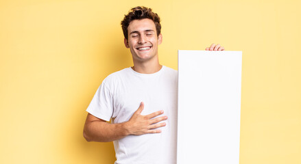 Wall Mural - laughing out loud at some hilarious joke, feeling happy and cheerful, having fun. empty canvas concept