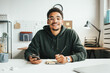 © Alex from the Rock - Investing in stock exchange market. Portrait of black casual man working using mobile phone app