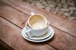 Dirty empty white coffee cups on saucers on a wooden background