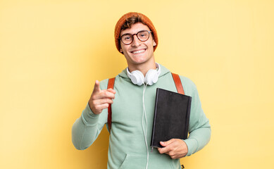 pointing at camera with a satisfied, confident, friendly smile, choosing you. student concept