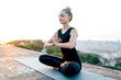 © ADDICTIVE STOCK - Fit woman doing Half Lotus position and zen gesture
