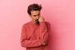 © Asier - Young caucasian man isolated on pink background who feels sad and pensive, looking at copy space.