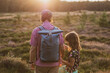 Father and daughter on a hike in the forest during sunset 
