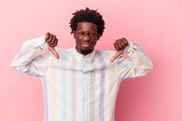 Wall Mural - Young african american man isolated on pink background showing thumb down, disappointment concept.