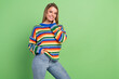© deagreez - Photo portrait smiling girl wearing striped pullover stylish jeans smiling isolated pastel green color background
