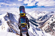 Snowboarder On Epic Mountain Summit Peak In Snow