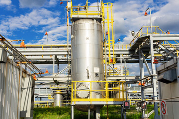 Part of a metal container at a liquefied gas production plant. Abstract view.