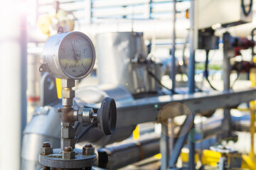 Industrial pressure gauge on the background of a chemical plant. Pressure gauge readings.