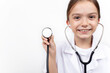 © eda - Portrait of a cute little girl dressed as a doctor with a stethoscope.