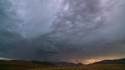 Wall Mural - Lightning flashing as storm clouds move over the landscape in Utah during sunset.