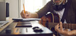 © Studio Romantic - Musician writing music. Songwriter who's following his passion sitting by electronic keyboard in home studio, holding pencil, picking guitar strings, thinking of lyrics for new song. Banner background
