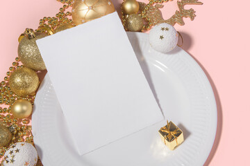 Wall Mural - Christmas vertical 5x7 card mockup torn edges with table setting white plate and golden decoration on pink background. Festive modern restaurant menu, congratulation or invitation, or greeting card