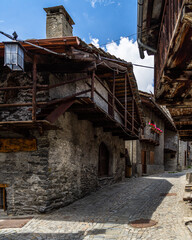 Canvas Print - Charming houses and buildings lined along the cobbled street in Pontechianale, Piedmont, Italy