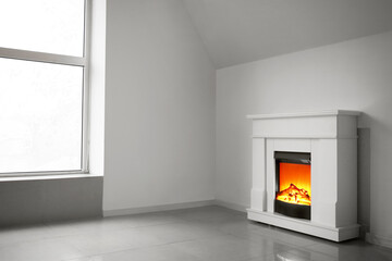 Modern fireplace in interior of empty light room