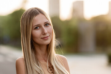 Wall Mural - Closeup Portrait of beautiful woman with blonde hair outdoor at hot summer day