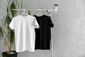 Poster - White and black T-shirts on hangers for design presentation