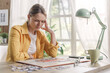 © StockPhotoPro - Woman solving a puzzle and having a headache