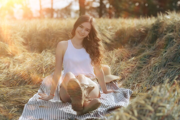 Wall Mural - wheat field summer landscape, happy young model / freedom and relaxation concept in summer and autumn