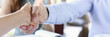 © H_Ko - Smiling man and woman shake hands as hello in office