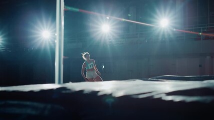 Wall Mural - High Jump Championship: Professional Female Athlete Running and Successfully Jumping over Bar. With Determination and Effort Celebrate Winning. Cinematic Light, Dolly Slow Motion Shot