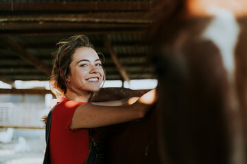 Girl grooming a chestnut horse