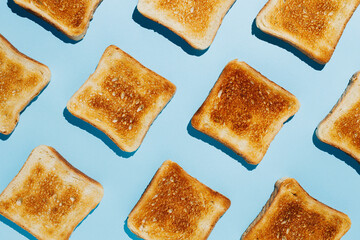 Wall Mural - Close up pattern of French toast loaves on a bright blue contrast background. Morning breakfast brunch concept. Modern minimal food photography collage in pop-art style. Flat lay.