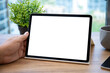 © DenPhoto - male hand holding computer tablet with isolated screen in office