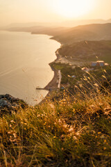 Wall Mural - Beautiful natural landscape with fluffy grass in the foreground on the top of the mountain