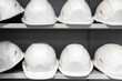 © kpn1968 - Construction white helmets stand in a row on the table.